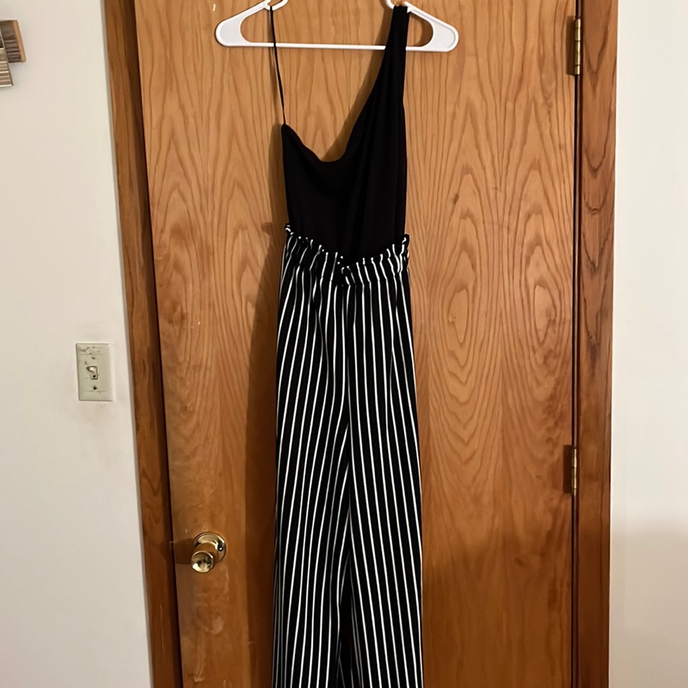 Women’s black VENUS jumpsuit. White stripe. Flared bottoms.